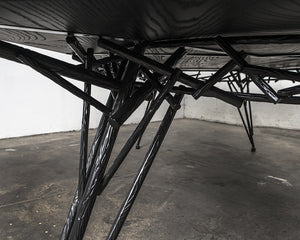 Photo of the Birdsnest Table made out of an ebonized white ash top and blackened steel base that resembles the branches of a birdsnest.