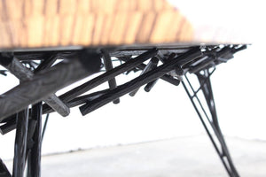 Photo of the Birdsnest Table made out of an ebonized white ash top and blackened steel base that resembles the branches of a birdsnest.